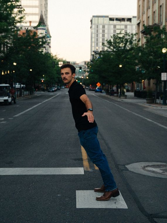 Trace Keller looking back over his shoulder in a downtown Boise street