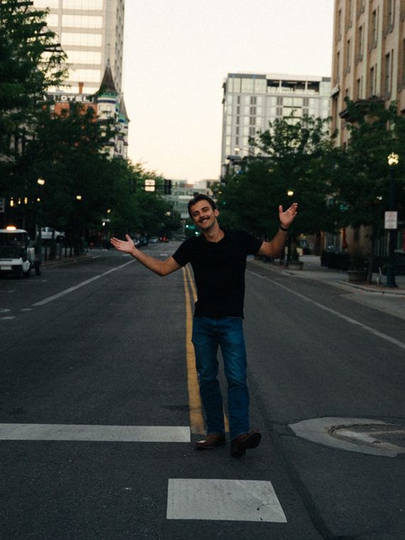 Trace Keller with his arms out in a downtown Boise street