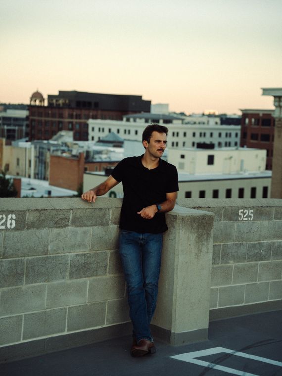 Trace Keller with his arms folded on a Boise rooftop wall