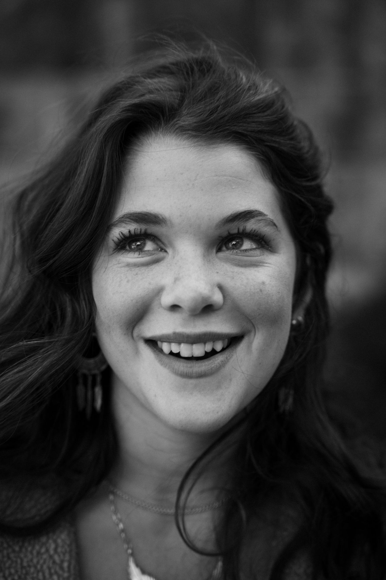 Close-up of Adeline laughing and looking up, in black and white