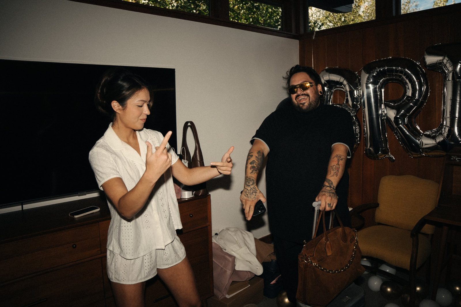 Becca and her stylist dancing and pointing at each other in the getting-ready room