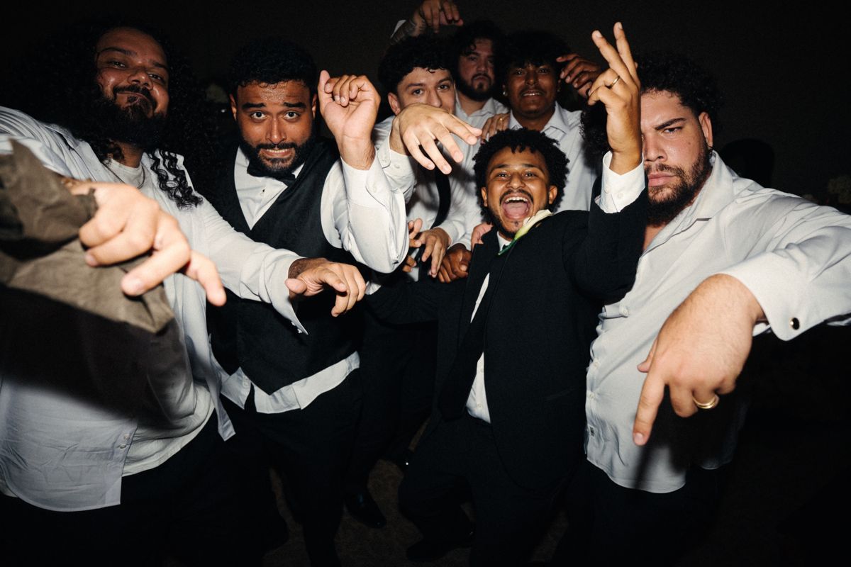 Groom and groomsmen dancing and laughing at a wedding reception in Idaho